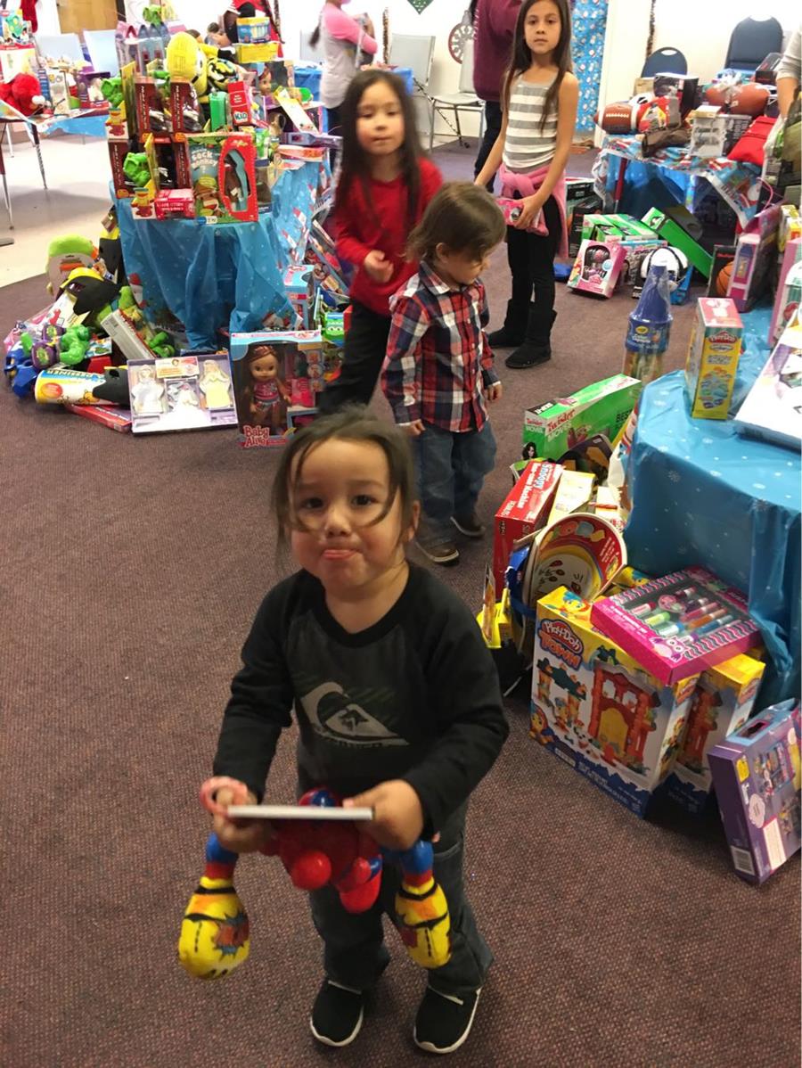 American Indian girl with Christmas gift from Wings of Faith and YOU!