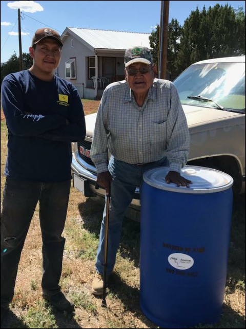 PHOTOS OF MEN WITH WATER BARREL AND WOMAN WITH WATER BARREL