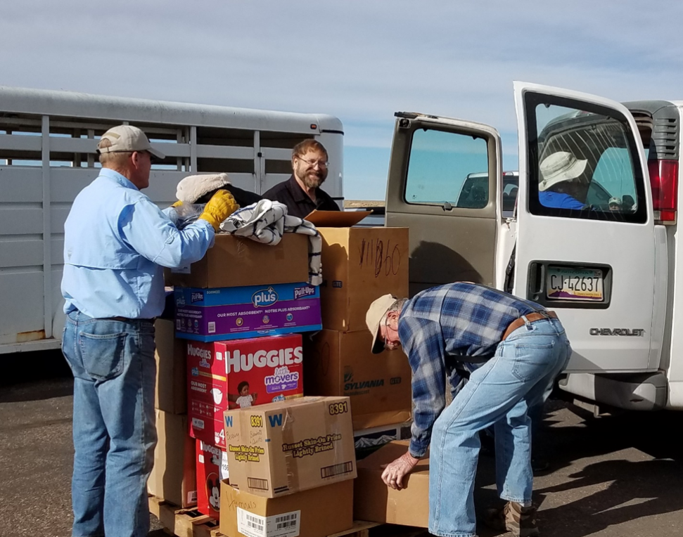 Pastor Wayne, center, receiving fall and winter supplies at the Holbrook, Arizona